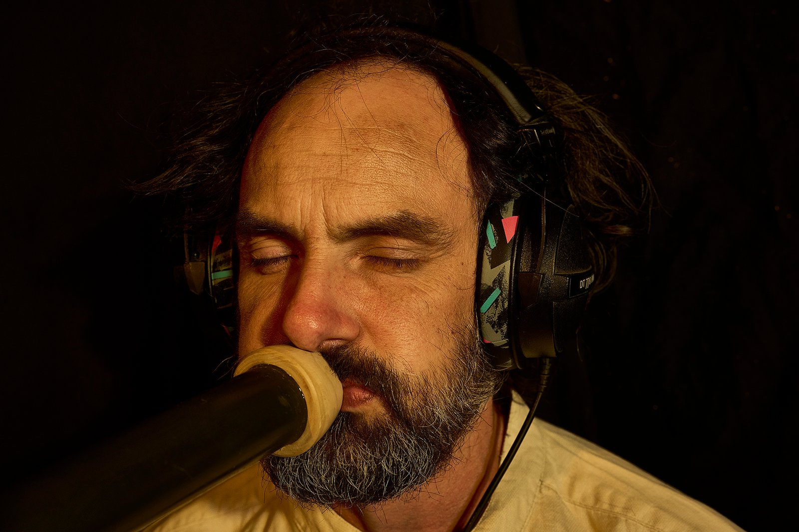 Eliah Jasper listening with headphones during a live performance