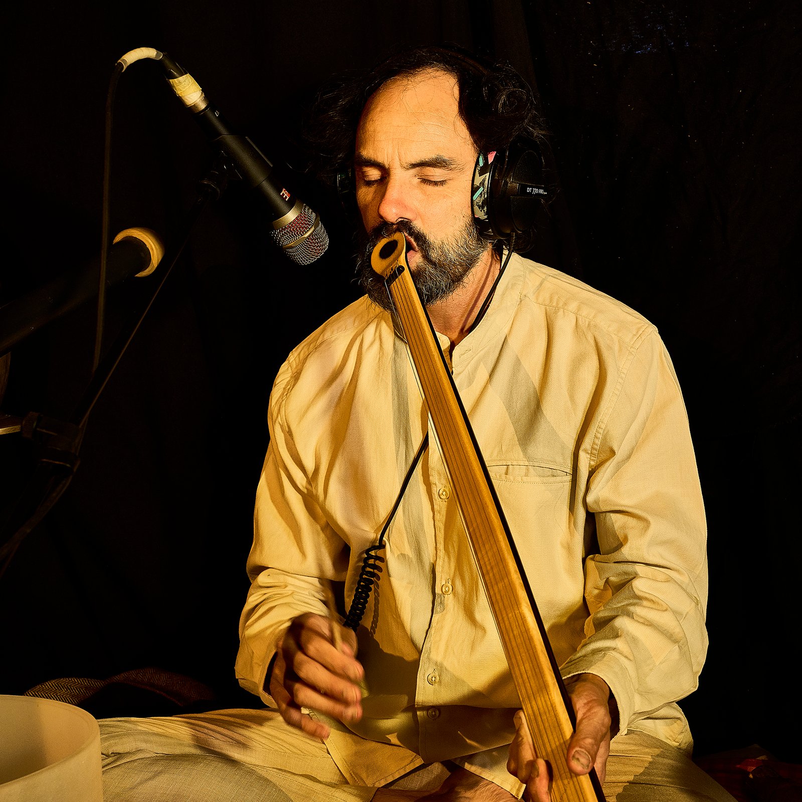Eliah Jasper performing live with headphones in the studio